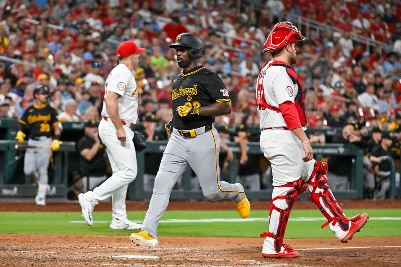 Jun 11, 2024; St. Louis, Missouri, USA;  Pittsburgh Pirates designated hitter Andrew McCutchen (22) runs past St. Louis Cardinals catcher Pedro Pages (43) and relief pitcher Ryan Helsley (56) to score on a sacrifice fly during the ninth inning at Busch Stadium. Mandatory Credit: Jeff Curry-USA TODAY Sports