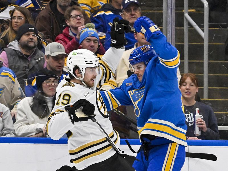 Jan 13, 2024; St. Louis, Missouri, USA;  St. Louis Blues left wing Sammy Blais (79) checks Boston Bruins center Johnny Beecher (19) during the second period at Enterprise Center. Mandatory Credit: Jeff Curry-USA TODAY Sports