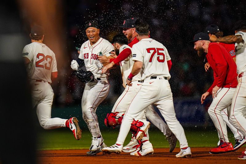 Aug 12, 2024; Boston, Massachusetts, USA; Boston Red Sox left fielder Rob Refsnyder (30) is congratulated after singling to center field to drive in the winning run against the Texas Rangers in the tenth inning at Fenway Park. Mandatory Credit: David Butler II-USA TODAY Sports