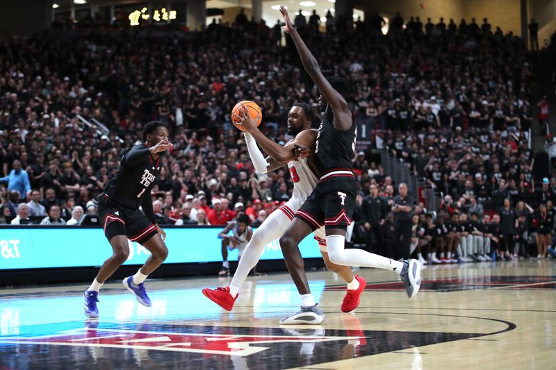 Feb 24, 2025; Lubbock, Texas, USA;  Houston Cougars forward J’Wan Roberts (13) drives to the lane against Texas Tech Red Raiders forward Federiko Federiko (33) in the first half  at United Supermarkets Arena. Mandatory Credit: Michael C. Johnson-Imagn Images