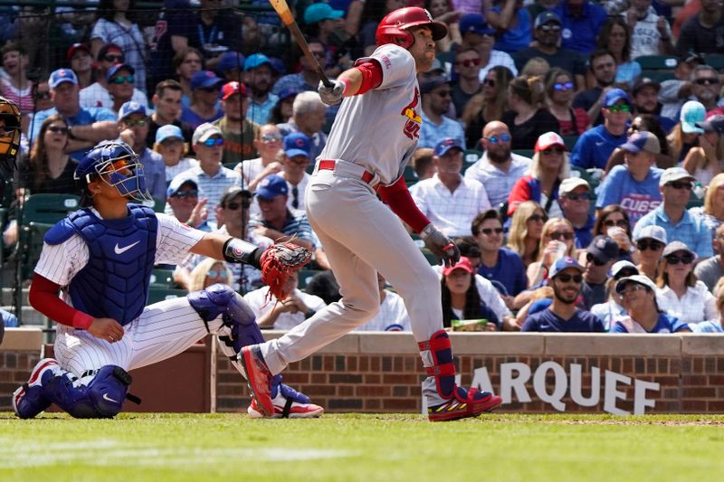 Jul 23, 2023; Chicago, Illinois, USA; St. Louis Cardinals center fielder Dylan Carlson (3) hits a one run single against the Chicago Cubs during the sixth inning at Wrigley Field. Mandatory Credit: David Banks-USA TODAY Sports