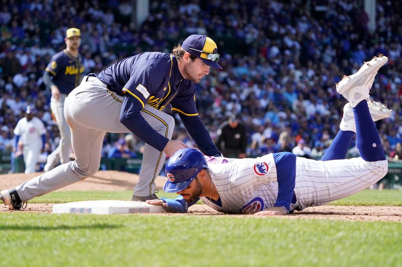 May 5, 2024; Chicago, Illinois, USA; Chicago Cubs outfielder Mike Tauchman (40) dives safely into first base as Milwaukee Brewers third base Tyler Black (7) makes a late tag during the seventh inning at Wrigley Field. Mandatory Credit: David Banks-USA TODAY Sports