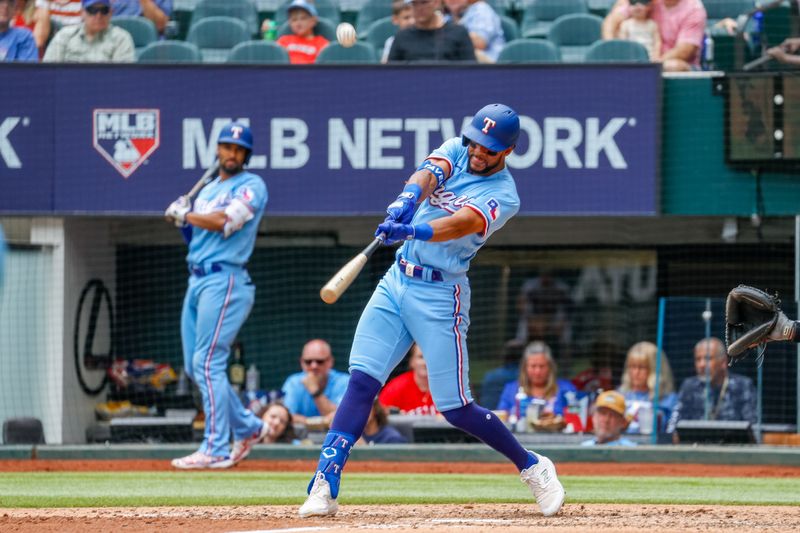 May 21, 2023; Arlington, Texas, USA; Texas Rangers center fielder Leody Taveras (3) hits a three run RBI double during the fifth inning against the Colorado Rockies at Globe Life Field. Mandatory Credit: Andrew Dieb-USA TODAY Sports