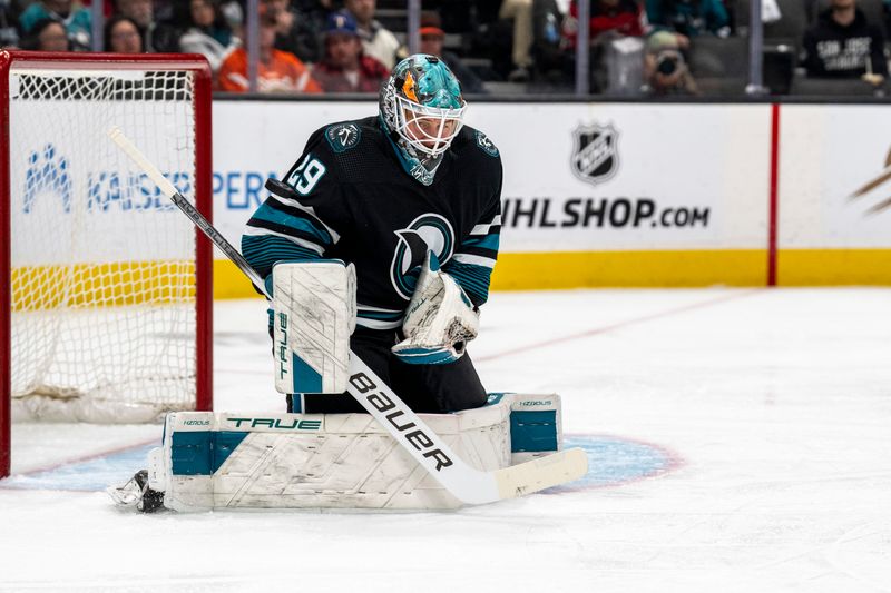 Feb 27, 2024; San Jose, California, USA;  San Jose Sharks goaltender Mackenzie Blackwood (29) deflects the shot on goal against New Jersey Devils during the first period at SAP Center at San Jose. Mandatory Credit: Neville E. Guard-USA TODAY Sports