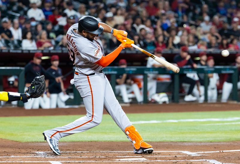 Sep 16, 2025; Phoenix, Arizona, USA; San Francisco Giants outfielder Jerar Encarnacion hits a two run double in the first inning against the Arizona Diamondbacks at Chase Field. Mandatory Credit: Mark J. Rebilas-Imagn Images
