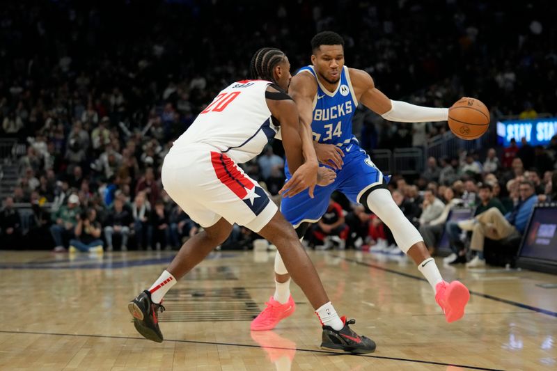 MILWAUKEE, WISCONSIN - NOVEMBER 30: Giannis Antetokounmpo #34 of the Milwaukee Bucks dribbles the ball against Alexandre Sarr #20 of the Washington Wizards during the first quarter of a game at Fiserv Forum on November 30, 2024 in Milwaukee, Wisconsin. NOTE TO USER: User expressly acknowledges and agrees that, by downloading and or using this photograph, User is consenting to the terms and conditions of the Getty Images License Agreement. (Photo by Patrick McDermott/Getty Images)