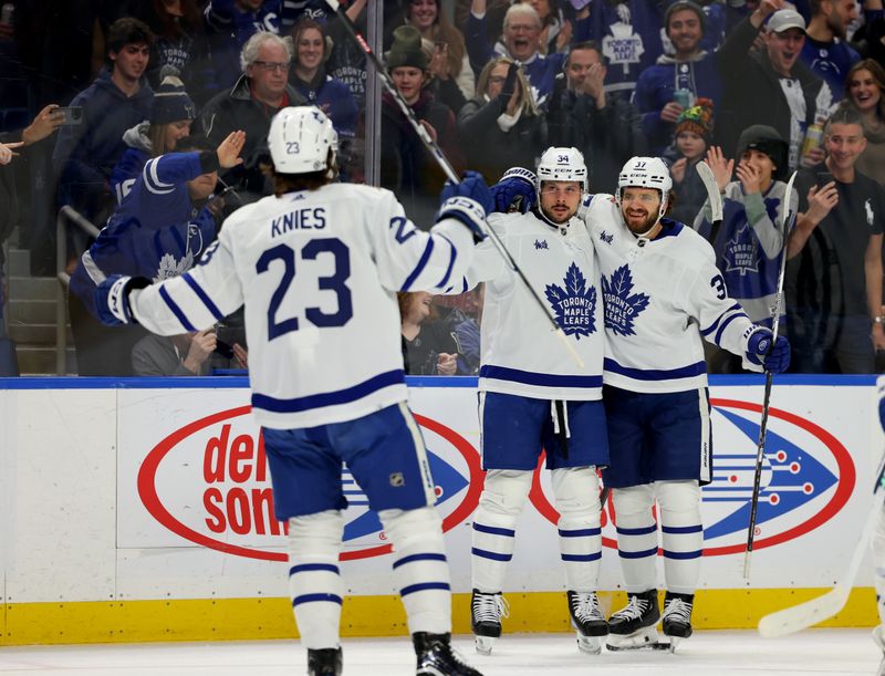 Dec 21, 2023; Buffalo, New York, USA;  Toronto Maple Leafs center Auston Matthews (34) celebrates his goal with teammates during the first period against the Buffalo Sabres at KeyBank Center. Mandatory Credit: Timothy T. Ludwig-USA TODAY Sports