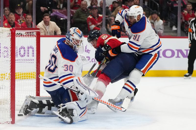 Nov 20, 2023; Sunrise, Florida, USA; Florida Panthers defenseman Niko Mikkola (77) scores a goal on Edmonton Oilers goaltender Calvin Pickard (30) during the second period at Amerant Bank Arena. Mandatory Credit: Jasen Vinlove-USA TODAY Sports