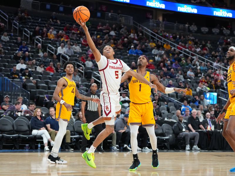 Mar 9, 2023; Las Vegas, NV, USA; USC Trojans guard Boogie Ellis (5) shoots inside the defense of Arizona State Sun Devils guard Luther Muhammad (1) during the second half at T-Mobile Arena. Mandatory Credit: Stephen R. Sylvanie-USA TODAY Sports