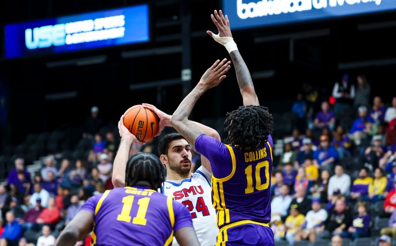 Dec 14, 2024; Frisco, Texas, USA;  Southern Methodist Mustangs center Samet Yigitoglu (24) looks to shoot as LSU Tigers forward Daimion Collins (10) and LSU Tigers forward Corey Chest (11) defend during the first half at Comerica Center. Mandatory Credit: Kevin Jairaj-Imagn Images