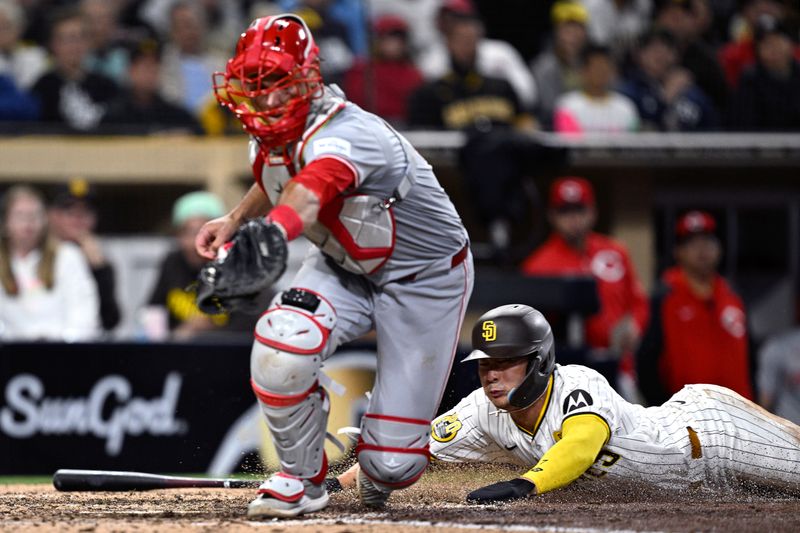 Apr 30, 2024; San Diego, California, USA; San Diego Padres shortstop Ha-Seong Kim (7) scores a run past Cincinnati Reds catcher Luke Maile (22) during the sixth inning at Petco Park. Mandatory Credit: Orlando Ramirez-USA TODAY Sports