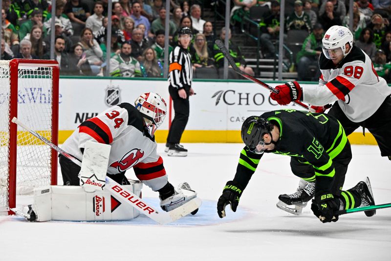 Mar 14, 2024; Dallas, Texas, USA; New Jersey Devils defenseman Kevin Bahl (88) is called for a cross check on Dallas Stars left wing Jamie Benn (14) as goaltender Jake Allen (34) covers the puck during the second period at the American Airlines Center. Mandatory Credit: Jerome Miron-USA TODAY Sports