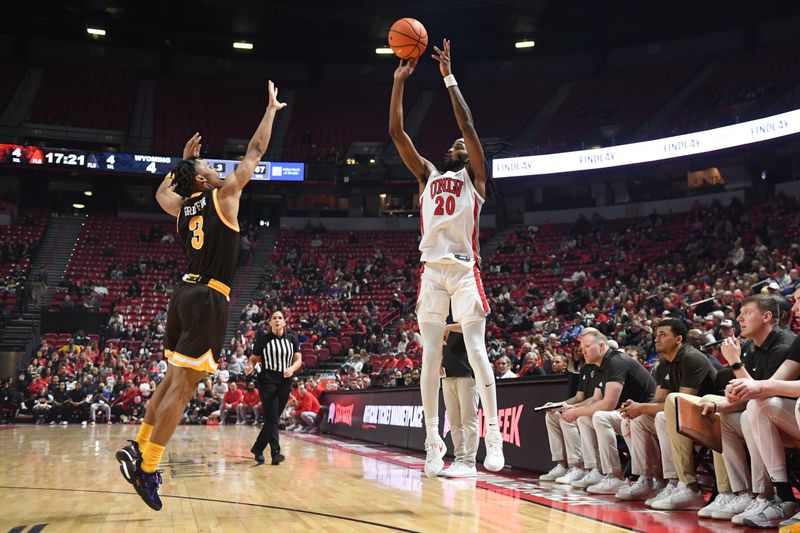 Feb 3, 2024; Las Vegas, Nevada, USA; UNLV Rebels forward Keylan Boone (20) scores on Wyoming Cowboys guard Sam Griffin (3) in the first half at Thomas & Mack Center. Mandatory Credit: Candice Ward-USA TODAY Sports