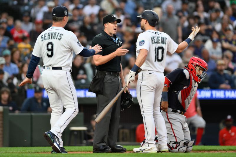 Jun 27, 2023; Seattle, Washington, USA; Home plate umpire Brennan Miller (55) and Seattle Mariners left fielder Jarred Kelenic (10) and manager Scott Servais (9) discuss a called hitters clock violation during the seventh inning at T-Mobile Park. Mandatory Credit: Steven Bisig-USA TODAY Sports