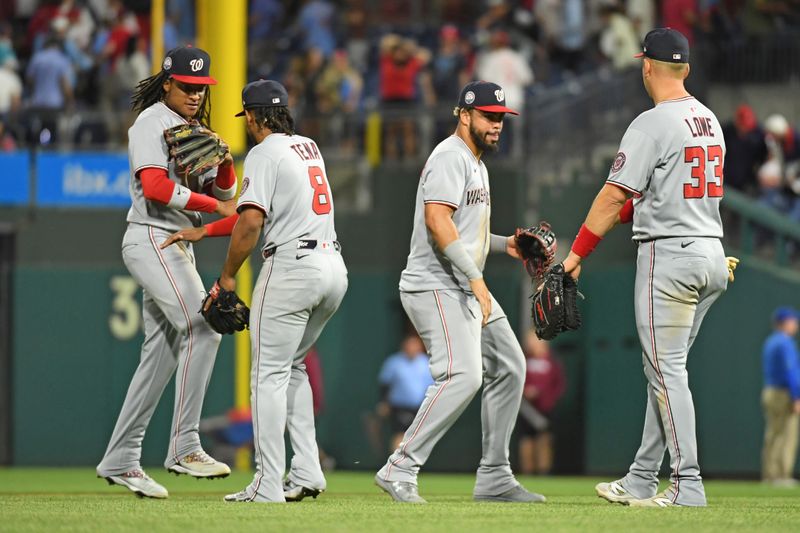 May 1, 2025; Philadelphia, Pennsylvania, USA; Washington Nationals shortstop CJ Abrams (5), third base José Tena (8), second base Luis García Jr. (2) and first base Nathaniel Lowe (33) celebrate win against the Philadelphia Phillies at Citizens Bank Park. Mandatory Credit: Eric Hartline-Imagn Images