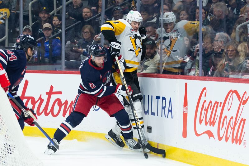 Feb 10, 2024; Winnipeg, Manitoba, CAN;  Winnipeg Jets defenseman Neal Pionk (4) boards Pittsburgh Penguins forward Evgeni Malkin (71) during the first period at Canada Life Centre. Mandatory Credit: Terrence Lee-USA TODAY Sports