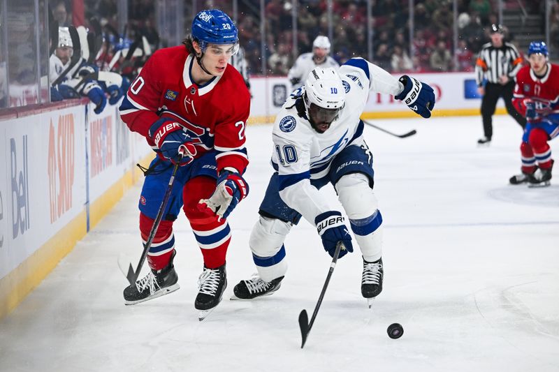 Apr 4, 2024; Montreal, Quebec, CAN; Tampa Bay Lightning left wing Anthony Duclair (10) defends the puck against Montreal Canadiens left wing Juraj Slafkovsky (20) during the first period at Bell Centre. Mandatory Credit: David Kirouac-USA TODAY Sports