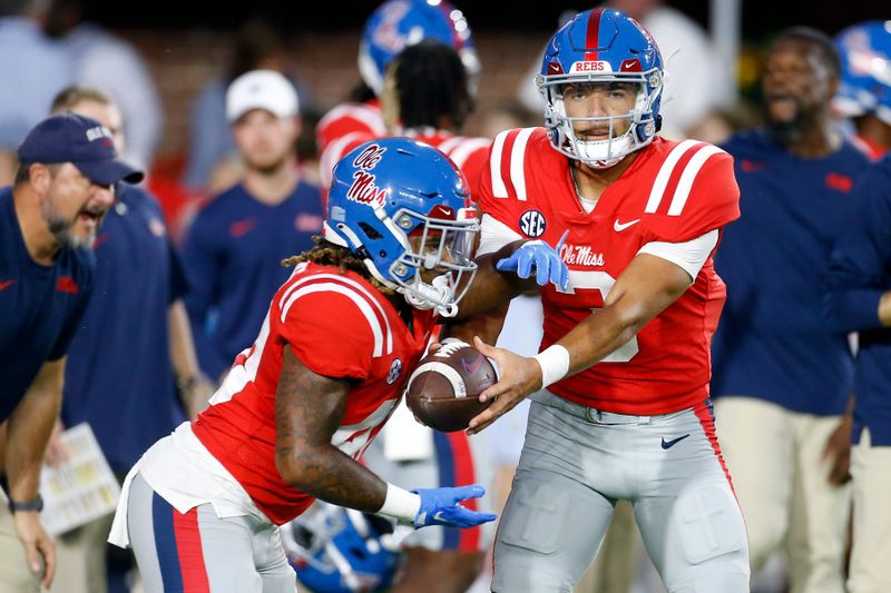 Oct 28, 2023; Oxford, Mississippi, USA; Mississippi Rebels quarterback Spencer Sanders (3) hands the ball off to running back Matt Jones (40) during warm ups prior to a game against the Vanderbilt Commodores at Vaught-Hemingway Stadium. Mandatory Credit: Petre Thomas-USA TODAY Sports