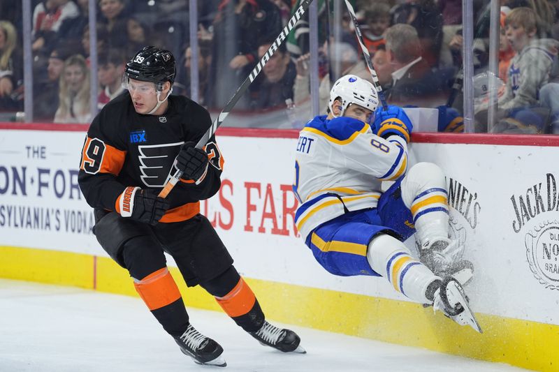 Nov 16, 2024; Philadelphia, Pennsylvania, USA; Philadelphia Flyers right wing Matvei Michkov (39) skates against Buffalo Sabres defenseman Dennis Gilbert (8) as he falls into the boards in the third period at Wells Fargo Center. Mandatory Credit: Kyle Ross-Imagn Images