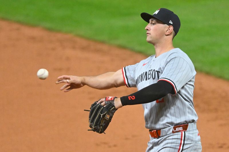 Apr 29, 2025; Cleveland, Ohio, USA; Minnesota Twins second baseman Brooks Lee (2) throws to first base in the second inning against the Cleveland Guardians at Progressive Field. Mandatory Credit: David Richard-Imagn Images