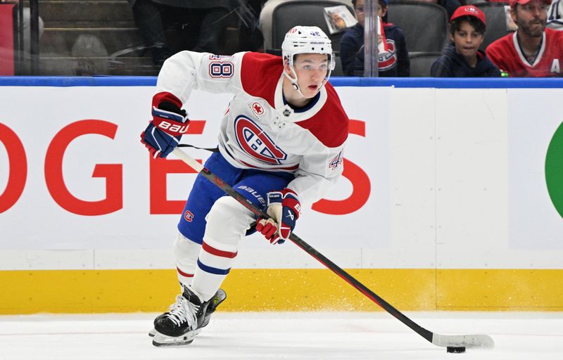 Sep 26, 2024; Toronto, Ontario, CAN;  Montreal Canadiens forward Lane Hutson (48) skates with the puck against the Toronto Maple Leafs in the first period at Scotiabank Arena. Mandatory Credit: Dan Hamilton-Imagn Images