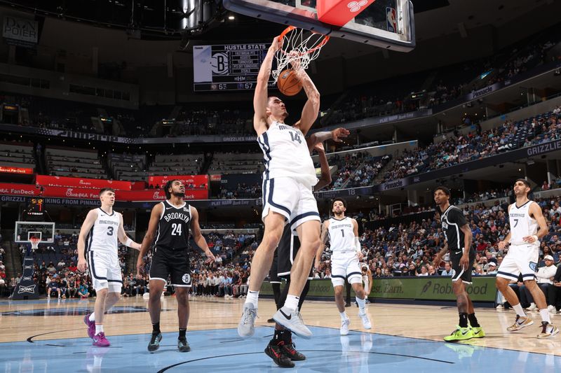 MEMPHIS, TN - OCTOBER 30: Zach Edey #14 of the Memphis Grizzlies dunks the ball during the game against the Brooklyn Nets on October 30, 2024 at FedExForum in Memphis, Tennessee. NOTE TO USER: User expressly acknowledges and agrees that, by downloading and or using this photograph, User is consenting to the terms and conditions of the Getty Images License Agreement. Mandatory Copyright Notice: Copyright 2024 NBAE (Photo by Joe Murphy/NBAE via Getty Images)