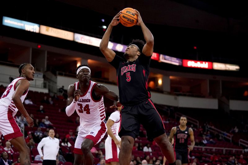 Feb 14, 2024; Fresno, California, USA; UNLV Rebels forward Rob Whaley Jr. (5) holds onto the ball next to Fresno State Bulldogs forward Pierre Geneste Jr. (34) in the first half at the Save Mart Center. Mandatory Credit: Cary Edmondson-USA TODAY Sports