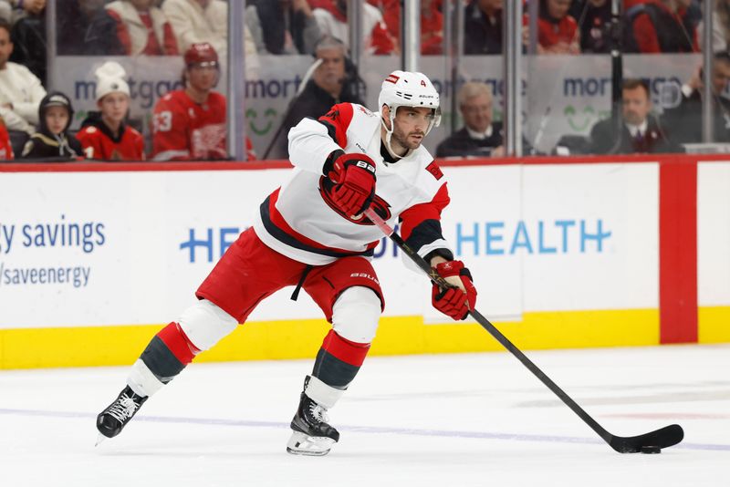 Jan 12, 2026; Detroit, Michigan, USA;  Carolina Hurricanes defenseman Shayne Gostisbehere (4) skates with the puck in the first period against the Detroit Red Wings at Little Caesars Arena. Mandatory Credit: Rick Osentoski-Imagn Images