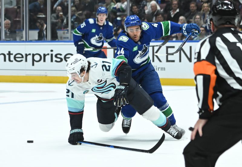 Apr 2, 2025; Vancouver, British Columbia, CAN; Vancouver Canucks forward Kiefer Sherwood (44) checks Seattle Kraken forward Michael Eyssimont (21) during the second periodat Rogers Arena. Mandatory Credit: Simon Fearn-Imagn Images