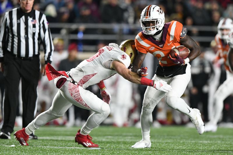 Nov 5, 2021; Chestnut Hill, Massachusetts, USA; Virginia Tech Hokies running back Malachi Thomas (24) rushes against Boston College Eagles defensive back Mike Palmer (18) during the second half at Alumni Stadium. Mandatory Credit: Brian Fluharty-USA TODAY Sports