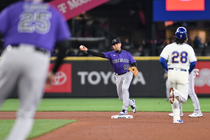 Apr 16, 2023; Seattle, Washington, USA; Colorado Rockies shortstop Alan Trejo (13) throws to first baseman C.J. Cron (25) to complete the double play against the Seattle Mariners during the fourth inning at T-Mobile Park. Mandatory Credit: Steven Bisig-USA TODAY Sports