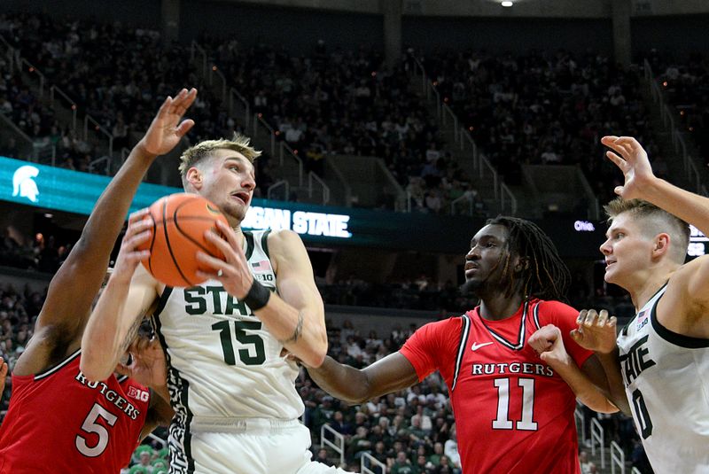 Mar 5, 2026; East Lansing, Michigan, USA;  Michigan State Spartans center Carson Cooper (15) controls a rebound during the second half against the Rutgers Scarlet Knights at Jack Breslin Student Events Center. Mandatory Credit: Dale Young-Imagn Images