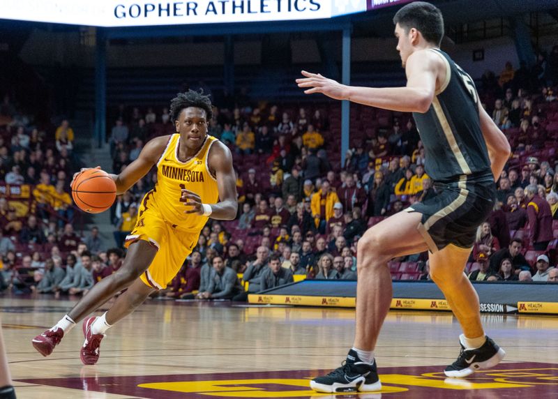 Jan 19, 2023; Minneapolis, Minnesota, USA; Minnesota Golden Gophers forward Joshua Ola-Joseph (1) drives on Purdue Boilermakers center Zach Edey (15) in the first half at Williams Arena. Mandatory Credit: Matt Blewett-USA TODAY Sports