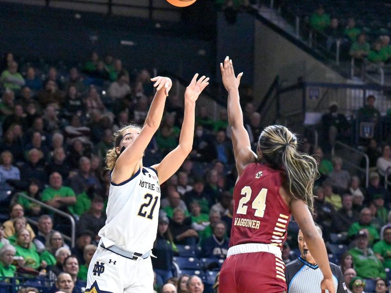 Jan 11, 2024; South Bend, Indiana, USA; Notre Dame Fighting Irish forward Maddy Westbeld (21) shoots a three point basket over Boston College Eagles guard Dontavia Waggoner (24) in the second half at the Purcell Pavilion. Mandatory Credit: Matt Cashore-USA TODAY Sports