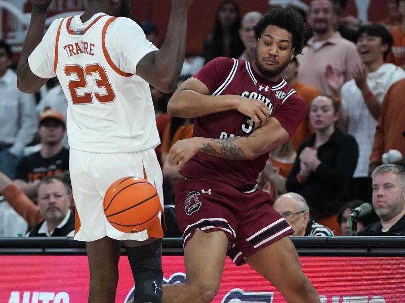 Feb 3, 2026; Austin, Texas, USA; Texas Longhorns guard Dailyn Swain (3) saves the ball against Texas Longhorns forward Lassina Traore (23) during the second half at Moody Center. Mandatory Credit: Dustin Safranek-Imagn Images