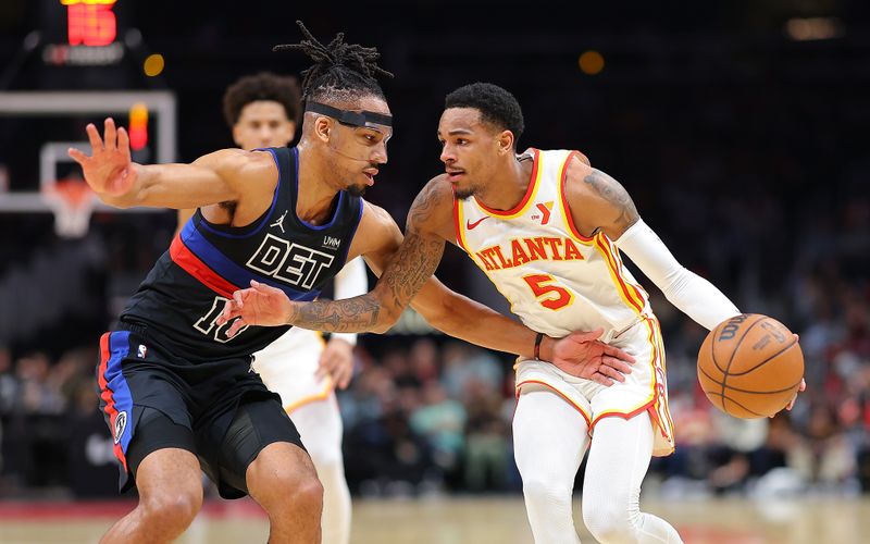 ATLANTA, GEORGIA - APRIL 03:  Dejounte Murray #5 of the Atlanta Hawks drives against Tosan Evbuomwan #18 of the Detroit Pistons during the second quarter at State Farm Arena on April 03, 2024 in Atlanta, Georgia.  NOTE TO USER: User expressly acknowledges and agrees that, by downloading and/or using this photograph, user is consenting to the terms and conditions of the Getty Images License Agreement.  (Photo by Kevin C. Cox/Getty Images)