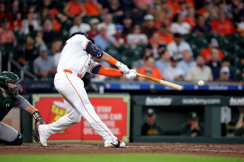 Sep 12, 2024; Houston, Texas, USA; Houston Astros first baseman Jon Singleton (28) hits a single against the Oakland Athletics during the fourth inning at Minute Maid Park. Mandatory Credit: Erik Williams-Imagn Images