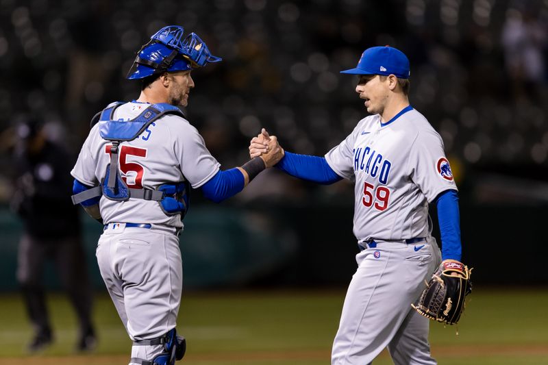 Apr 18, 2023; Oakland, California, USA; after Chicago Cubs catcher Yan Gomes (15) and relief pitcher Michael Rucker (59) celebrate after defeating the Oakland Athletics at RingCentral Coliseum. Mandatory Credit: John Hefti-USA TODAY Sports