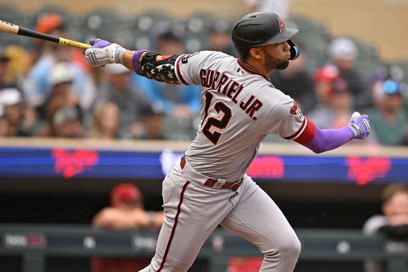 Aug 6, 2023; Minneapolis, Minnesota, USA;  Arizona Diamondbacks outfielder Lourdes Gurriel (12) hits a double against the Minnesota Twins during the seventh inning at Target Field. Mandatory Credit: Nick Wosika-USA TODAY Sports