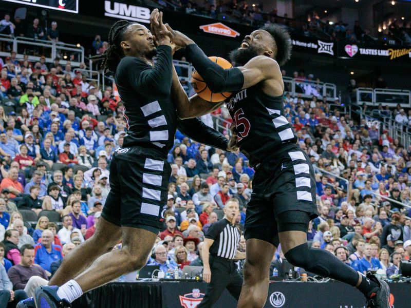 Mar 13, 2024; Kansas City, MO, USA; Cincinnati Bearcats forward John Newman III (15) and Cincinnati Bearcats forward Kalu Ezikpe (1) collide going after a rebound during the first halfat T-Mobile Center. Mandatory Credit: William Purnell-USA TODAY Sports