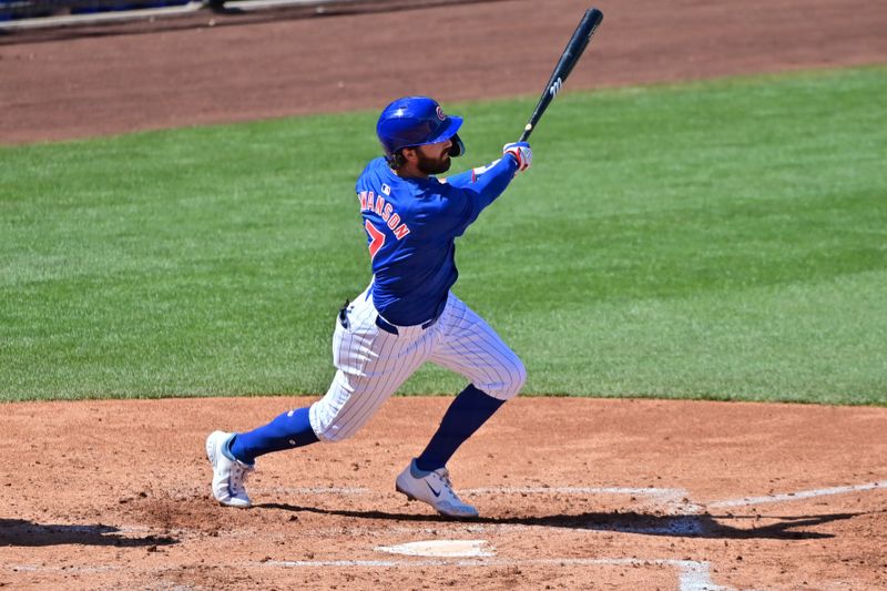 Mar 8, 2024; Mesa, Arizona, USA;  Chicago Cubs shortstop Dansby Swanson (7) hits an RBI single in the second inning against the Seattle Mariners during a spring training game at Sloan Park. Mandatory Credit: Matt Kartozian-USA TODAY Sports