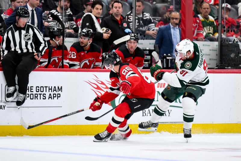 Oct 22, 2025; Newark, New Jersey, USA; Minnesota Wild right wing Vladimir Tarasenko (91) skates with the puck while defended by New Jersey Devils center Jack Hughes (86) during the third period at Prudential Center. Mandatory Credit: John Jones-Imagn Images