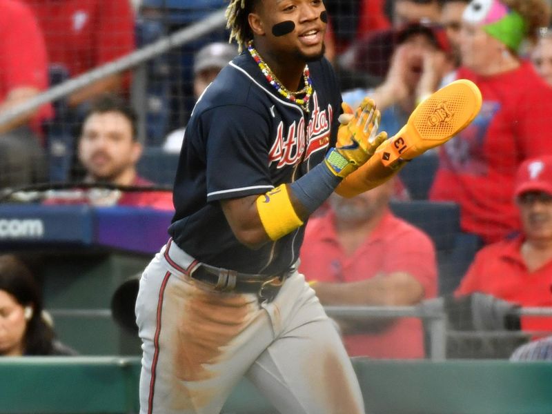 Oct 11, 2023; Philadelphia, Pennsylvania, USA; Atlanta Braves right fielder Ronald Acuna Jr. (13) reacts after scoring a run during the third inning against the Philadelphia Phillies in game three of the NLDS for the 2023 MLB playoffs at Citizens Bank Park. Mandatory Credit: Eric Hartline-USA TODAY Sports