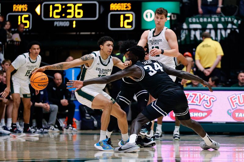 Feb 17, 2024; Fort Collins, Colorado, USA; Colorado State Rams guard Nique Clifford (10) controls the ball under pressure from Utah State Aggies forward Kalifa Sakho (34) and guard Ian Martinez (4) as forward Patrick Cartier (12) defends in the first half at Moby Arena. Mandatory Credit: Isaiah J. Downing-USA TODAY Sports