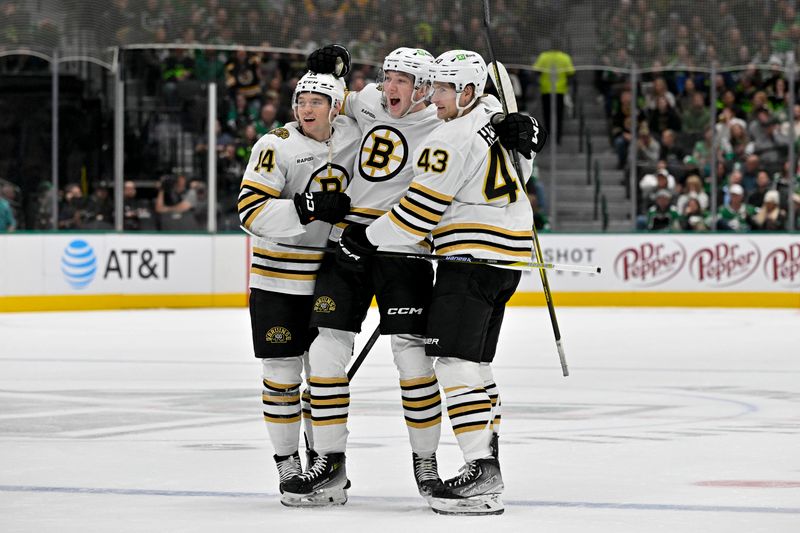 Nov 6, 2023; Dallas, Texas, USA; Boston Bruins defenseman Ian Mitchell (14) and defenseman Mason Lohrei (6) and left wing Danton Heinen (43) celebrates a goal scored by Lohrei against the Dallas Stars during the first period at the American Airlines Center. Mandatory Credit: Jerome Miron-USA TODAY Sports