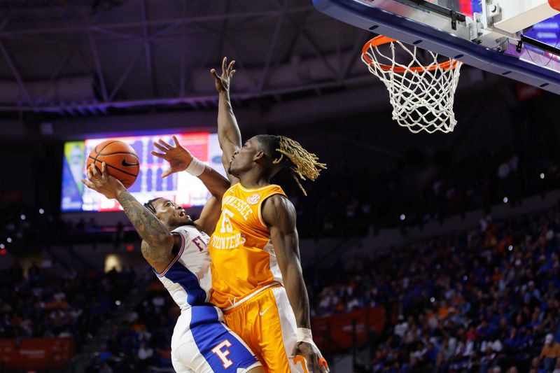 Jan 7, 2025; Gainesville, Florida, USA; Florida Gators guard Alijah Martin (15) shoots over Tennessee Volunteers guard Jahmai Mashack (15) during the second half at Exactech Arena at the Stephen C. O'Connell Center. Mandatory Credit: Matt Pendleton-Imagn Images