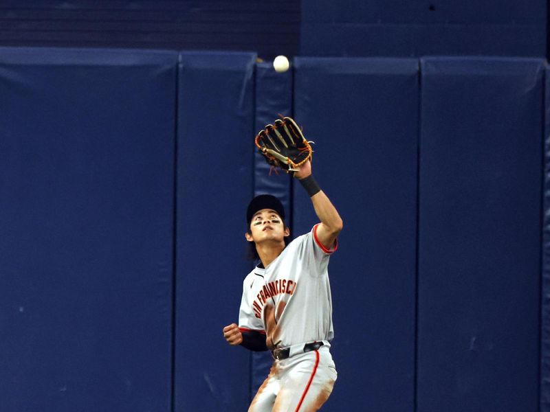 Apr 12, 2024; St. Petersburg, Florida, USA; San Francisco Giants outfielder Jung Hoo Lee (51) catches a fly ball during the sixth inning against the Tampa Bay Rays at Tropicana Field. Mandatory Credit: Kim Klement Neitzel-USA TODAY Sports