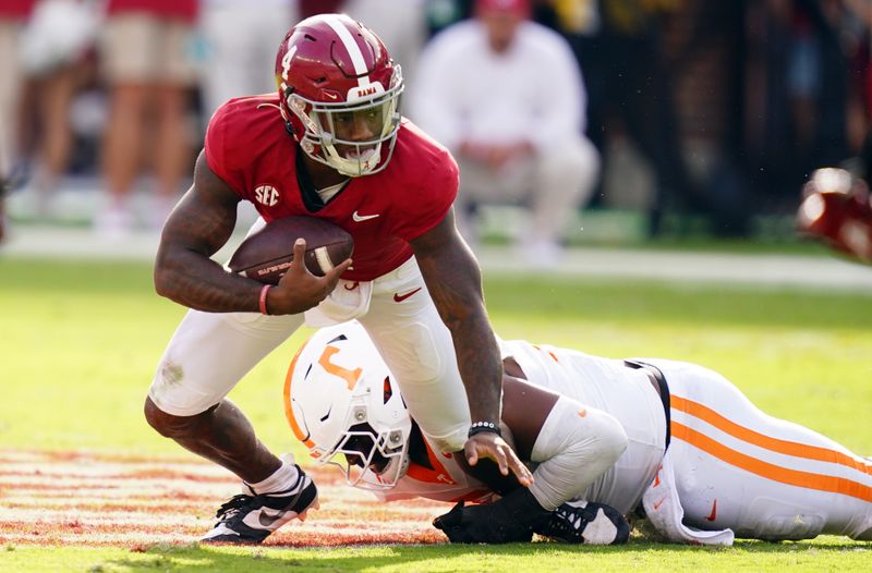 Oct 21, 2023; Tuscaloosa, Alabama, USA; Alabama Crimson Tide quarterback Jalen Milroe (4) gets sacked behind the line of scrimmage by Tennessee Volunteers defensive lineman Omarr Norman-Lott (55) during the first half at Bryant-Denny Stadium. Mandatory Credit: John David Mercer-USA TODAY Sports