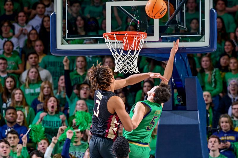 Jan 17, 2023; South Bend, Indiana, USA; Notre Dame Fighting Irish guard Cormac Ryan (5) is fouled by Florida State Seminoles forward Cam Corhen (3) in the first half at the Purcell Pavilion. Mandatory Credit: Matt Cashore-USA TODAY Sports