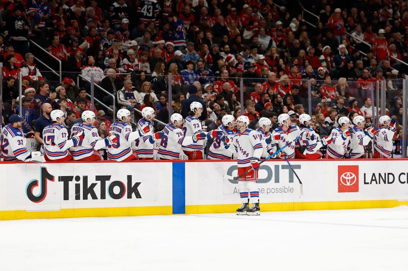 Dec 23, 2025; Washington, District of Columbia, USA; New York Rangers right wing Taylor Raddysh (14) celebrates with teammates after scoring a goal against the Washington Capitals during the third period at Capital One Arena. Mandatory Credit: Geoff Burke-Imagn Images